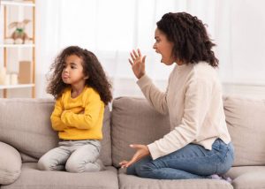 ngry Afro Mother Shouting At Offended Daughter Sitting On Couch At Home. Family Problems, Quarrels And Aggression